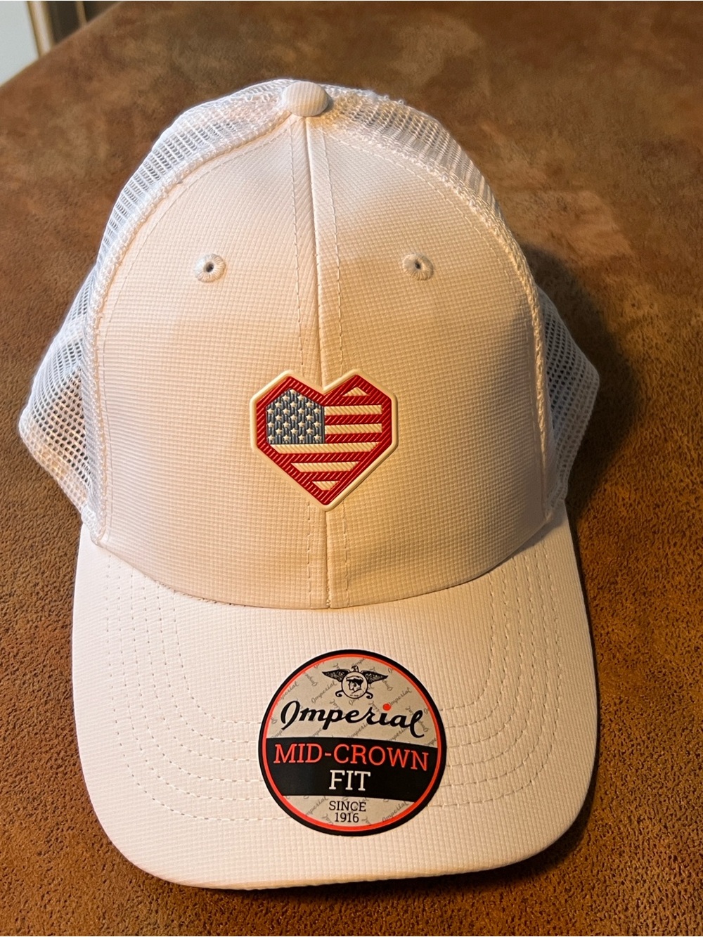 Imperial White Trucker Hat with American Flag Heart Patch. Spanish peaks big sky